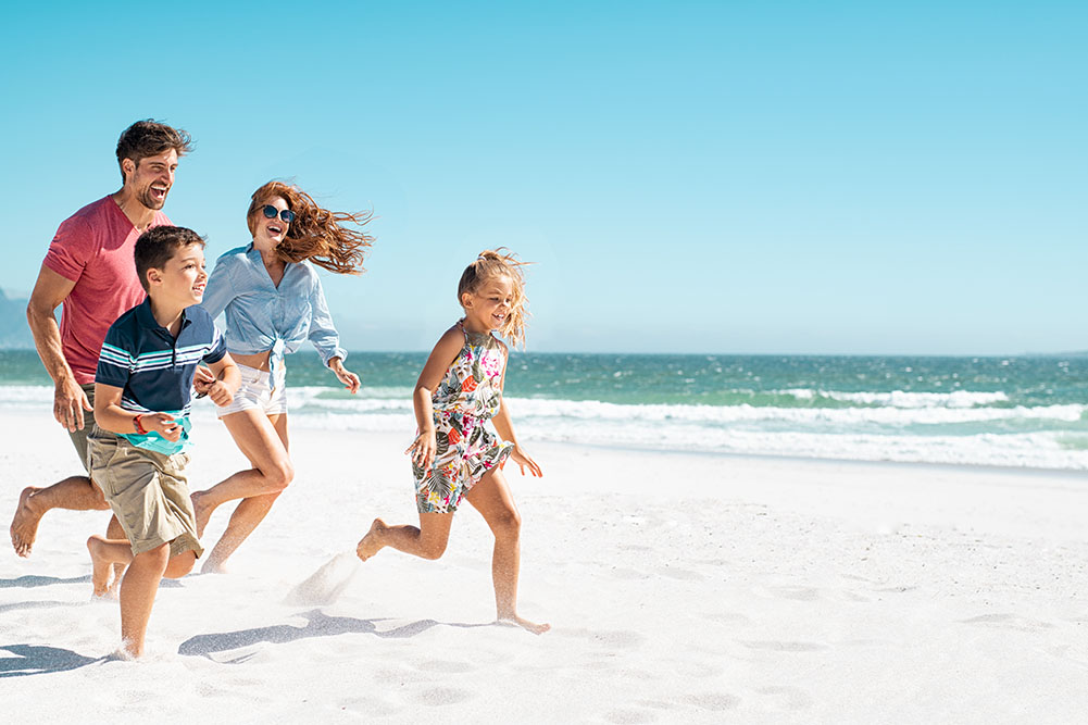 Happy Healthy Family Running on Beach