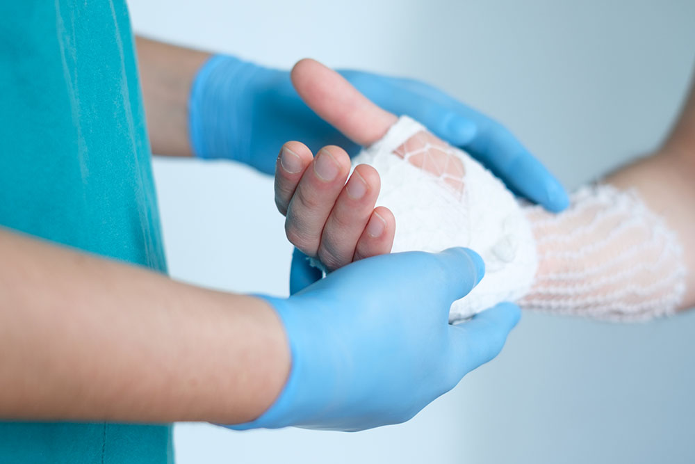 Close Up of Doctor Bandaging Hand